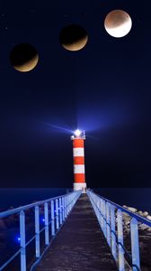 Preview wallpaper lighthouse, eclipse, moon, night, pier