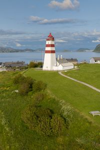 Preview wallpaper lighthouse, field, grass, sea, sky
