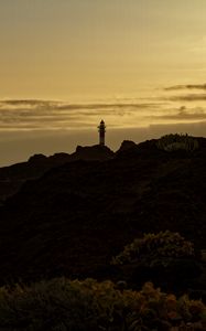 Preview wallpaper lighthouse, hills, silhouettes, evening