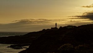 Preview wallpaper lighthouse, hills, silhouettes, evening