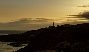 Preview wallpaper lighthouse, hills, silhouettes, evening