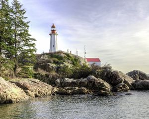 Preview wallpaper lighthouse, house, stones, shore, sea