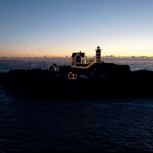 Preview wallpaper lighthouse, houses, neon, island, sea, twilight