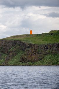 Preview wallpaper lighthouse, island, sea, cliff, grass