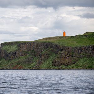 Preview wallpaper lighthouse, island, sea, cliff, grass