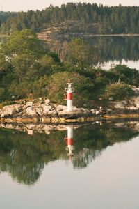 Preview wallpaper lighthouse, island, trees, reflection, lake