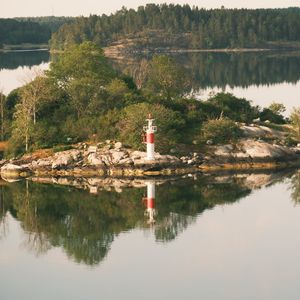 Preview wallpaper lighthouse, island, trees, reflection, lake