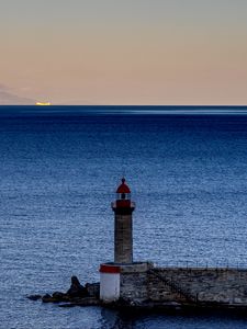 Preview wallpaper lighthouse, ocean, water, waves, twilight