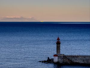 Preview wallpaper lighthouse, ocean, water, waves, twilight