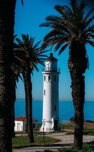 Preview wallpaper lighthouse, palm trees, sea, building, architecture, coast