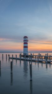 Preview wallpaper lighthouse, pier, sea, sunset, sky