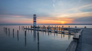 Preview wallpaper lighthouse, pier, sea, sunset, sky