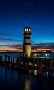 Preview wallpaper lighthouse, pier, sea, lights, twilight