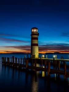 Preview wallpaper lighthouse, pier, sea, lights, twilight