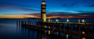 Preview wallpaper lighthouse, pier, sea, lights, twilight
