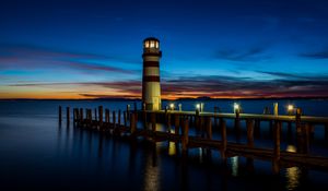 Preview wallpaper lighthouse, pier, sea, lights, twilight