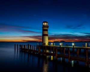 Preview wallpaper lighthouse, pier, sea, lights, twilight