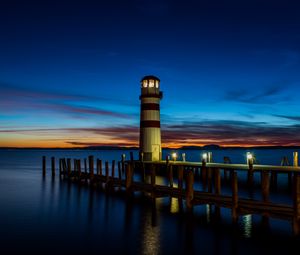Preview wallpaper lighthouse, pier, sea, lights, twilight