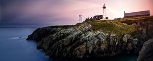 Preview wallpaper lighthouse, rock, cliff, sea, rays