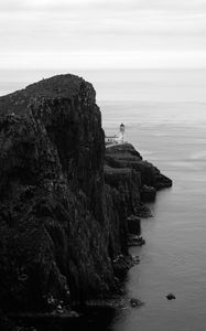 Preview wallpaper lighthouse, rock, cliff, sea, black and white