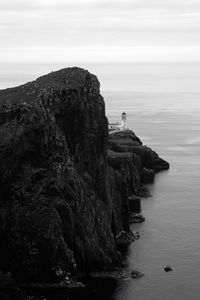 Preview wallpaper lighthouse, rock, cliff, sea, black and white