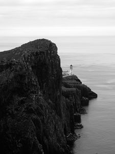 Preview wallpaper lighthouse, rock, cliff, sea, black and white