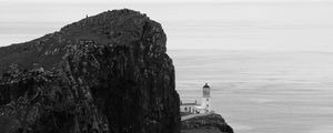 Preview wallpaper lighthouse, rock, cliff, sea, black and white