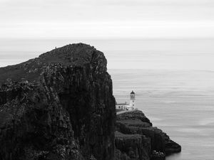 Preview wallpaper lighthouse, rock, cliff, sea, black and white