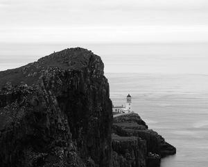 Preview wallpaper lighthouse, rock, cliff, sea, black and white