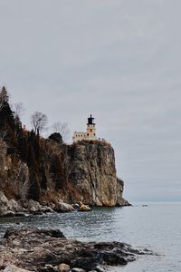 Preview wallpaper lighthouse, rock, sea, shore, nature