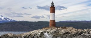 Preview wallpaper lighthouse, rock, sea, spray, mountains