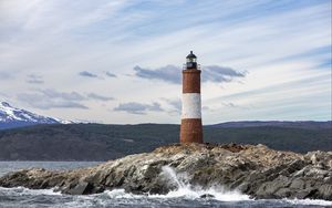 Preview wallpaper lighthouse, rock, sea, spray, mountains