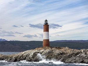 Preview wallpaper lighthouse, rock, sea, spray, mountains