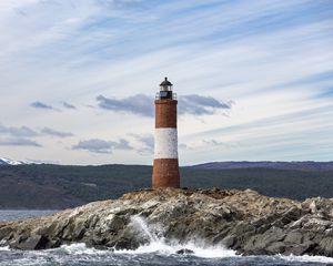 Preview wallpaper lighthouse, rock, sea, spray, mountains