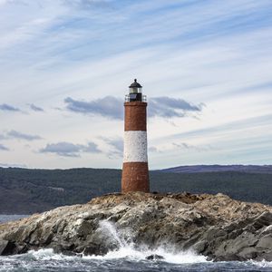 Preview wallpaper lighthouse, rock, sea, spray, mountains