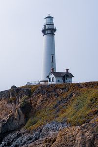 Preview wallpaper lighthouse, rock, slope, relief