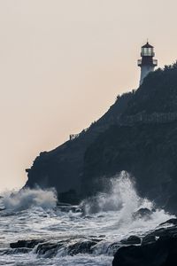 Preview wallpaper lighthouse, rock, waves, sea, shore