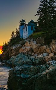 Preview wallpaper lighthouse, rocks, cliff, sea, sunset