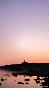 Preview wallpaper lighthouse, rocks, dusk, sunset, sea