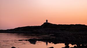 Preview wallpaper lighthouse, rocks, dusk, sunset, sea