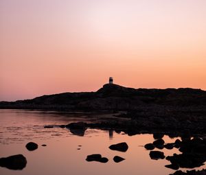 Preview wallpaper lighthouse, rocks, dusk, sunset, sea