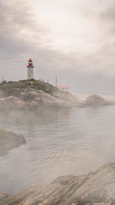 Preview wallpaper lighthouse, rocks, fog, coast, water