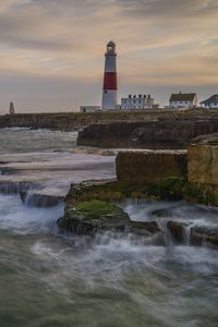Preview wallpaper lighthouse, rocks, sea, waves, landscape