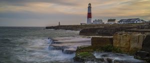 Preview wallpaper lighthouse, rocks, sea, waves, landscape