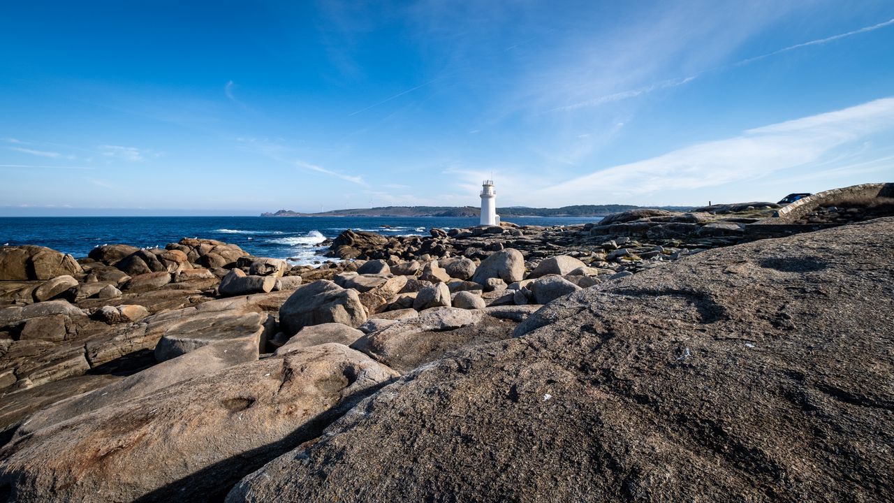 Wallpaper lighthouse, rocks, stones, sea, clouds, nature