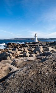 Preview wallpaper lighthouse, rocks, stones, sea, clouds, nature