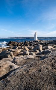 Preview wallpaper lighthouse, rocks, stones, sea, clouds, nature