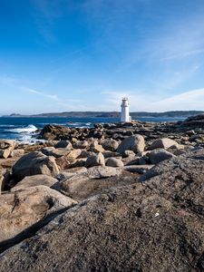 Preview wallpaper lighthouse, rocks, stones, sea, clouds, nature