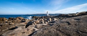 Preview wallpaper lighthouse, rocks, stones, sea, clouds, nature