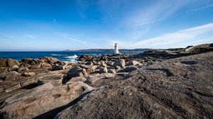 Preview wallpaper lighthouse, rocks, stones, sea, clouds, nature